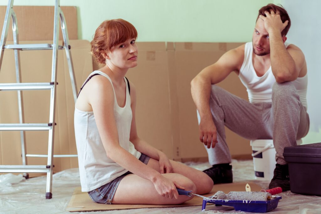 shot,of,a,tired,young,couple,sitting,on,a,floor